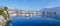 Extra wide view of  Ascona with houses with colorful facades reflecting on Lake Maggiore