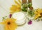 Extract, flowers, ingredient cosmetic cream on a white wooden background