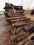 Extracted old wooden ties in stock. Old oiled used oak railway sleepers stored after reconstruction
