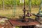 Extraction of good quality oil. Oil well pumpjack on vineyard in Czech Republic. Southern Moravia Region.