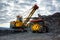 Extraction of iron quartzite in a quarry, loading rock mass into a large dump truck