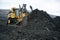 Extraction of minerals. Heavy powerful bulldozer in the quarry