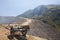 Extraction of sulfur from the crater of the volcano. The cart at the crater of the volcano. Mountain landscape