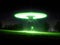 Extraterrestrial Encounter: Green Flying Saucer in a Field