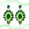 Extravagant big green earrings on a white background with decoration