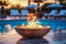 Extravagant round outdoor poolside fire pit, casting a warm and inviting glow, adding an element of luxury and intimacy to sunset