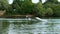 Extreme businessman in a suit with a tie and sunglasses rides on wakeboard on a lake