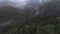 Extreme close flight over treetops in the misty forest morning. Aerial shot on fpv sport drone over clouds nature valley
