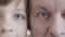 Extreme close-up of eyes of grandfather and grandson looking at camera. Portrait of senior Caucasian man and little boy