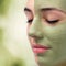 Extreme close up facial seaweed pealing on young woman