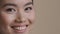Extreme close-up female face asian race girl cosmetology service client dental dentistry patient woman looking at camera