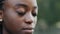 Extreme close-up female face with natural makeup perfect even dark skin, african american woman young girl lady standing