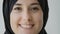 Extreme close-up female portrait indoors 20s smiling Arabian lady smile toothy dental with white teeth Muslim female