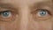 Extreme close up front view man face eyes. Blue grey male eyes. Man eye with different emotions. Smile serious angry