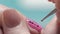 Extreme Close-up, Manicure Master Decorates Girl`s Nail, Puts on Pink Lacquer Brilliant Dots