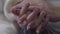 Extreme close-up of mature caucasian hands. Man caressing wife\'s hand. Eternal love, relationship, unity, togetherness.