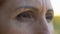 Extreme close-up of mature woman eyes, sad retired lady looking into camera