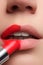 Extreme close up on model applying red lipstick. Makeup. Professional fashion retro make-up. Red lipstick.