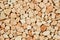 Extreme close up natural stone carpet, beige and cream coloured in different shades and tints of beige. Decorative stone coating.