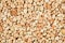 Extreme close up natural stone carpet, beige and cream coloured in different shades and tints of beige. Decorative stone coating.