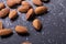 Extreme close-up of nutritious almonds with salt on black background