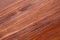 Extreme close up of a pine wooden surface, finished with dark wood stain, patina and matte varnish