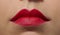 Extreme close up portrait of woman& x27;s plump lips with red lipstick. High quality photo image