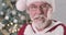 Extreme close-up of Santa Claus\'s face in eyeglasses making displeased face, looking at camera, shaking head and signing