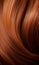 Extreme close-up shot of hair texture, with slight curves brown with copper highlights
