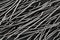 Extreme close up, top down view of end hooked steel macro fibers for concrete reinforcement. Construction industry background
