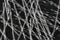 Extreme close up, top down view of polypropylene crimped macro fibers for concrete reinforcement on black stone background