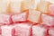 Extreme close up of traditional bulgarian rose flavoured and ordinary turkish delight cubes with powdered sugar icing