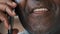 Extreme close up unknown unrecognizable male face african american adult senior 60s man businessman grandfather client