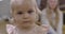 Extreme close-up of very beautiful Caucasian baby girl with blond hair and deep grey eyes. Portrait of lovely little