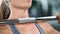 Extreme closeup girl raising up heavy barbell practicing bodybuilding. Shot with RED camera in 4K