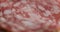 Extreme closeup laying salami slices on ciabatta