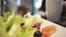 Extreme closeup of vegetable salad, woman serving healthy breakfast for family