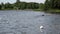 Extreme competition participants floating on finfoam over lake water.