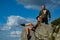 Extreme couple in love traveling and camping. Couple of tourist relaxing on top of a mountain and enjoying the view of