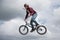 Extreme driving a bicycle.Professional rider is jumping on the bicycle, with