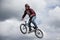 Extreme driving a bicycle.Professional rider is jumping on the bicycle, with