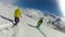 Extreme friends riding snowboards down snowy mountain slope, active leisure