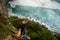 Extreme guy standing on a cliff by the ocean