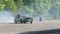 Extreme hobby, car performs drift and slides along asphalt into smoke on open air