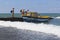 Extreme landing people with wet breakwater on the beach in the resort settlement of Adler in motorboat for sea walks. Sochi