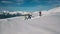 Extreme long shot group of active winter sport people dancing and having fun surrounded by snow