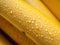 Extreme macro illustration of piece of banana in zoom. Water droplets are on the banana.