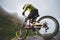 Extreme mountain bike sports athlete man in helmet riding outdoors against a background of rocks. Lifestyle. Trial