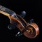 The extreme part of the violin fretboard is on a black background. A close-up of a tin box and a classic curl. For music news. A s