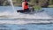 Extreme rider on a jet ski makes a beautiful sharp u-turn. The water is flying in different directions. Very dynamically.